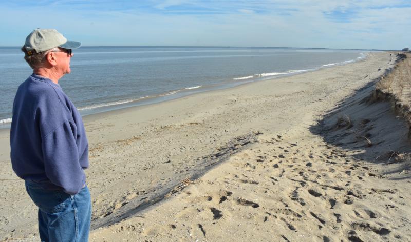 Broadkill Beach resident Jim Bailey would like DNREC Secretary Shawn Garvin to sign an agreement with the U.S. Army Corps of Engineers that would outline the path forward if the beach needed to be replenished in the future. Here, Bailey stands on what remains of a dune built in 2016. CHRIS FLOOD PHOTO